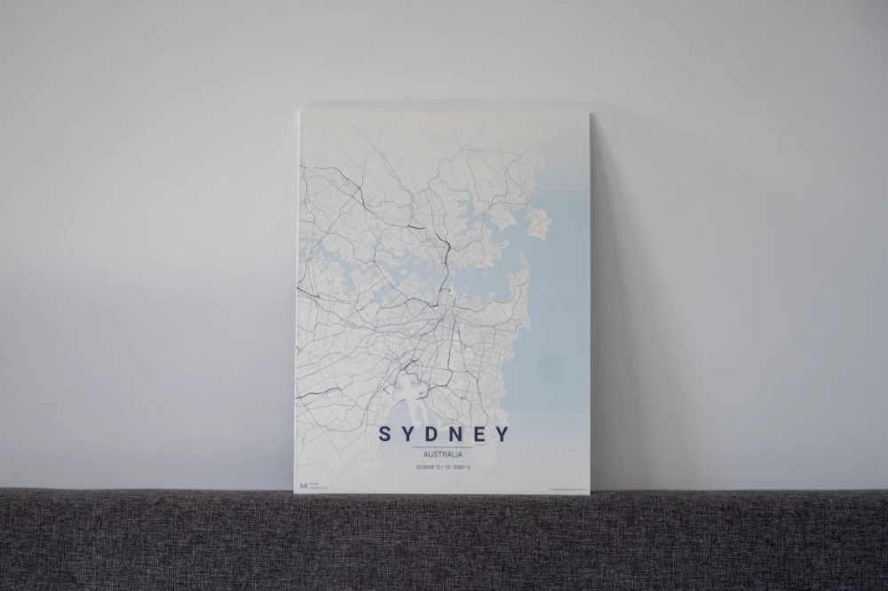 Sydney wood-board map leaning on a headboard