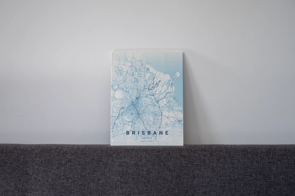 Wood-board city map leaning on a sofa back